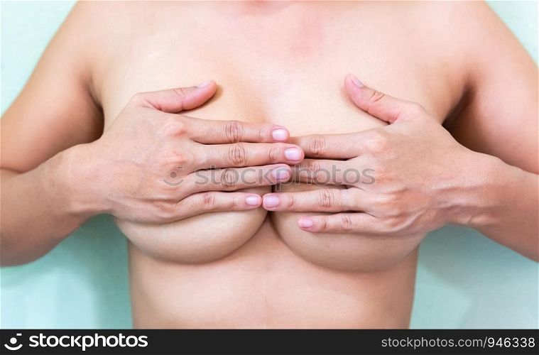 Female controlling breast for cancer, isolated on white background