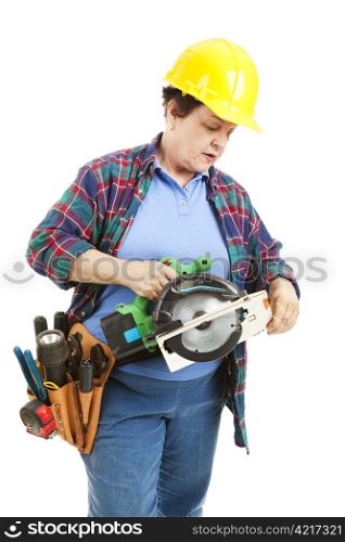 Female contruction worker trying to figure out how to use a circular saw.