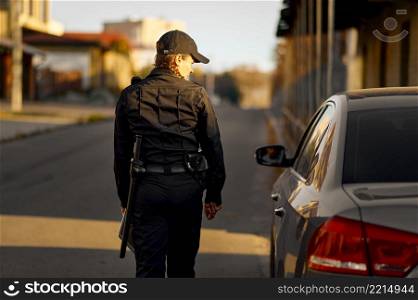 Female cop coming to car. Road patrol police service. Moving violation such as exceeding speed limit. Female cop coming to car on road