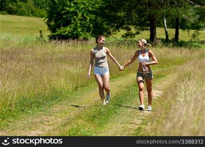 Female couple walking in nature on a sunny day