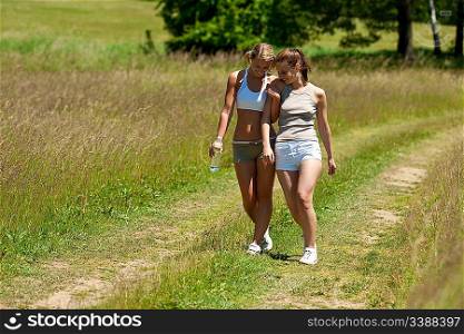 Female couple walking in nature on a sunny day
