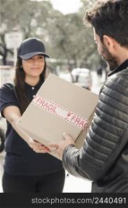 female courier delivering parcel man