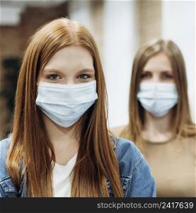 female coworkers wearing medical masks work