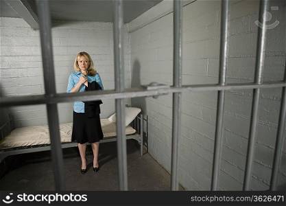 Female criminal behind bars in jail