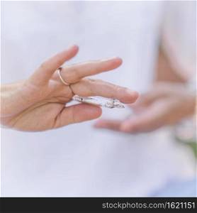 Female crystal healing spiritual therapist holding white polished selenite crystal wand and increasing positive inner energy. Hand gesture. Increasing Positive Energy with Crystal, Practicing Mindfulness