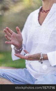 Female crystal healing therapist meditating, manifesting abundance with white selenite crystal. Energy work. Manifesting Abundance, Mindful Meditation with Crystals