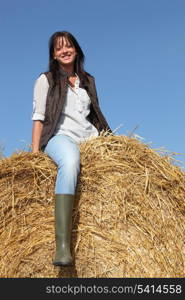 female cultivator posing on hay bale