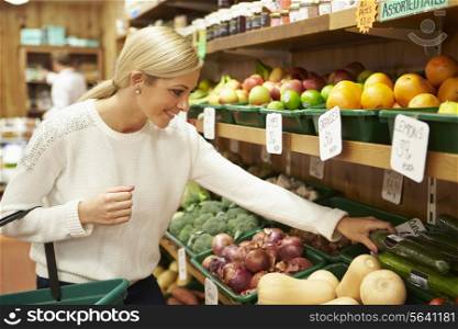 Female Customer At Vegetable Counter Of Farm Shop
