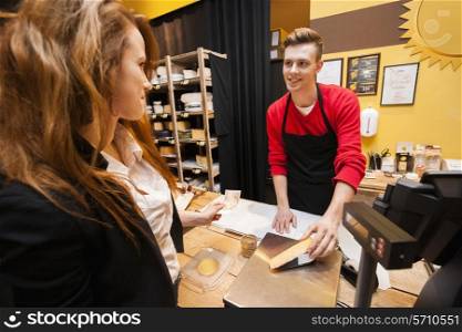 Female customer buying cheese at store