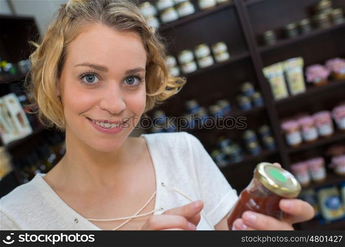 female customer holding a jar of jam