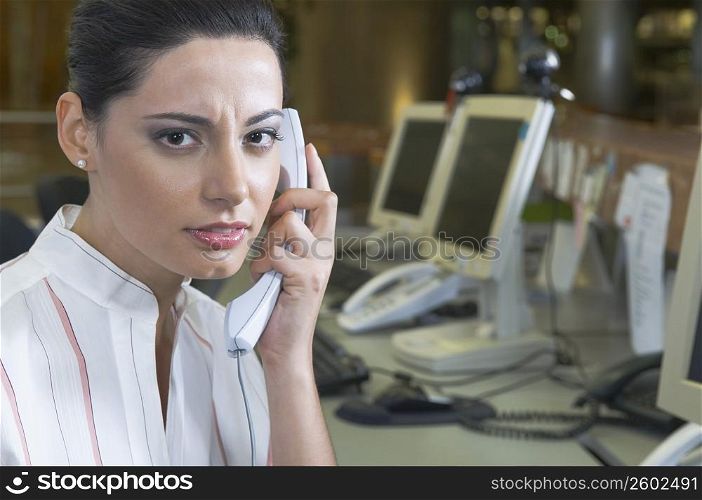 Female customer service representative talking on the telephone