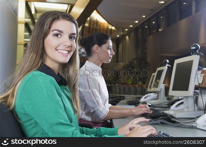 Female customer service representatives working in an office