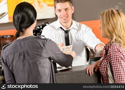 Female customers paying by cash czech crowns to cafe bartender