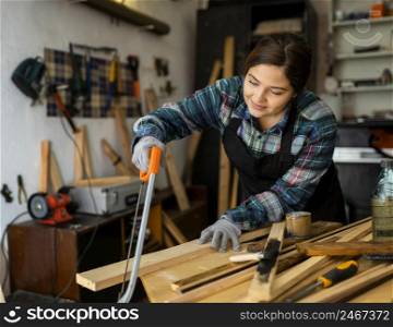 female cutting wood plank