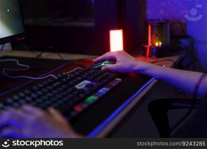Female cyber hacker gamer using keyboard and mouse to playing games or hacking programming system.