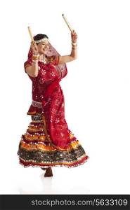 Female dandiya dancer dancing with sticks