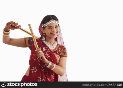 Female dandiya dancer dancing with sticks