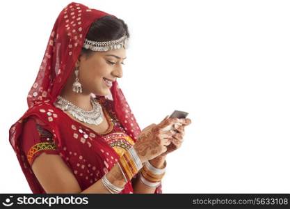 Female dandiya dancer reading an sms