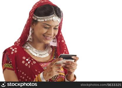 Female dandiya dancer reading an sms