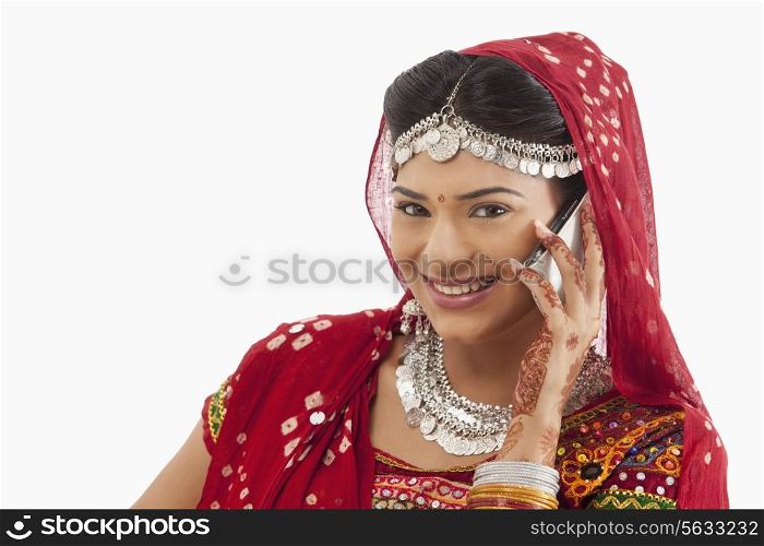 Female dandiya dancer talking on a mobile phone