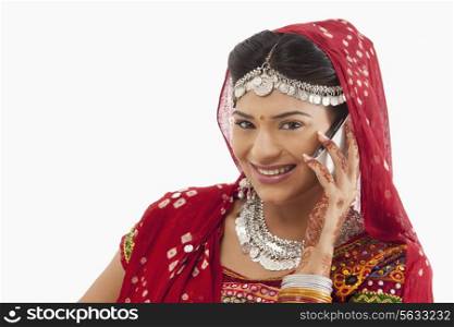 Female dandiya dancer talking on a mobile phone