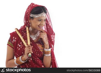Female dandiya dancer with sticks