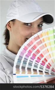 Female decorator choosing color from swatch