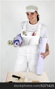 Female decorator holding wallpaper