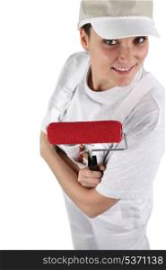 Female decorator with a red roller