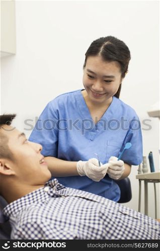 Female Dental Assistant Giving Treatment