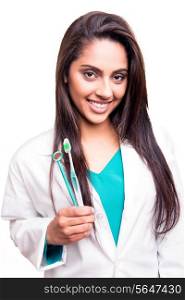 Female dentist doctor showing dental mirror and toothbrush