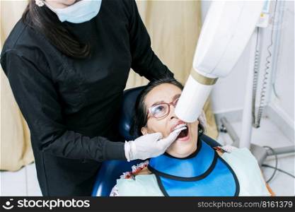 Female dentist doing dental x-ray, Female dentist doing x-ray to patient, female dentist doing dental x-ray, dental x-ray concept