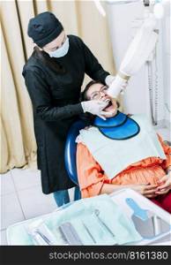 Female dentist doing dental x-ray, Female dentist doing x-ray to patient, female dentist doing dental x-ray, dental x-ray concept