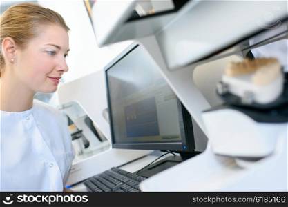 Female dentist sat at her computer