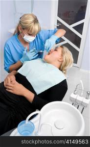 female dentist works with patient the office. female dentist works with patient at office