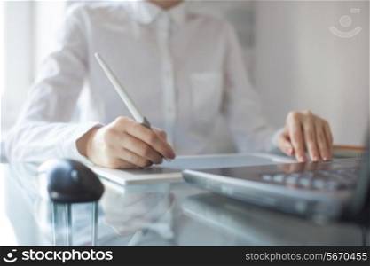 Female designer using graphics pad in office