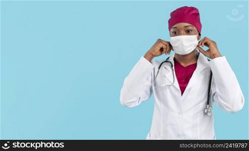female doctor adjusting her surgeon mask