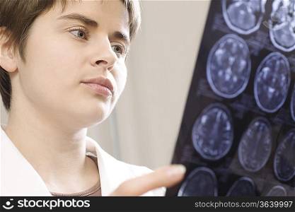 Female doctor analyzing CAT scan
