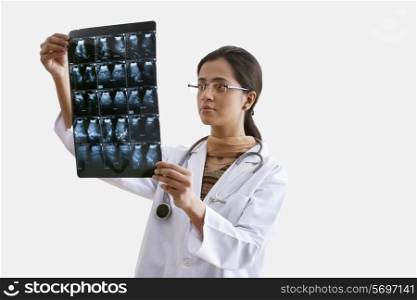 Female doctor analyzing ultrasound report isolated over white background