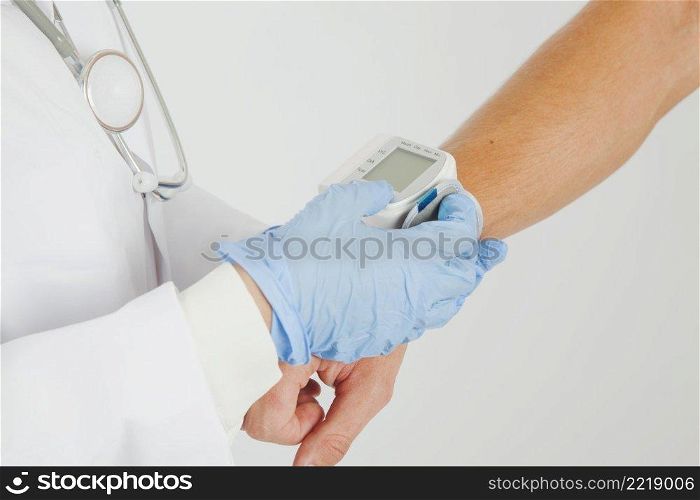 female doctor checking blood pressure arm