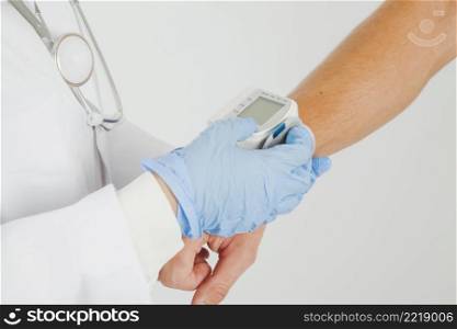 female doctor checking blood pressure arm
