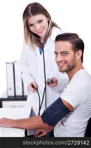 Female doctor checking blood pressure to her male patient