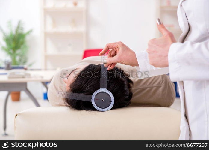 Female doctor checking patient&rsquo;s joint flexibility with goniometer . Female doctor checking patient&rsquo;s joint flexibility with goniometer