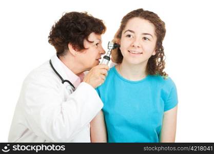 Female doctor checks inside the ears of her teenage patient. Isolated on white.
