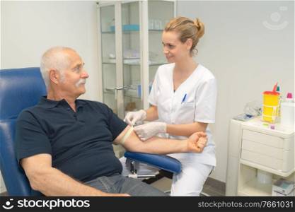 female doctor collecting patients blood for test