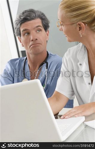 Female doctor discussing with a male surgeon