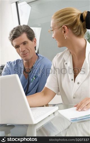 Female doctor discussing with a male surgeon at a clinic