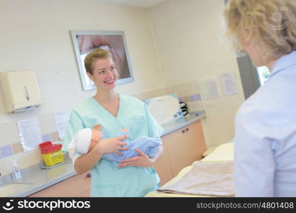 female doctor examines a newborn