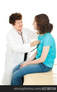 Female doctor examining a teenage girl, listening to her heartbeat with a stethoscope. Isolated.