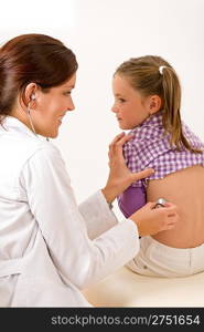 Female doctor examining child with stethoscope at medical office